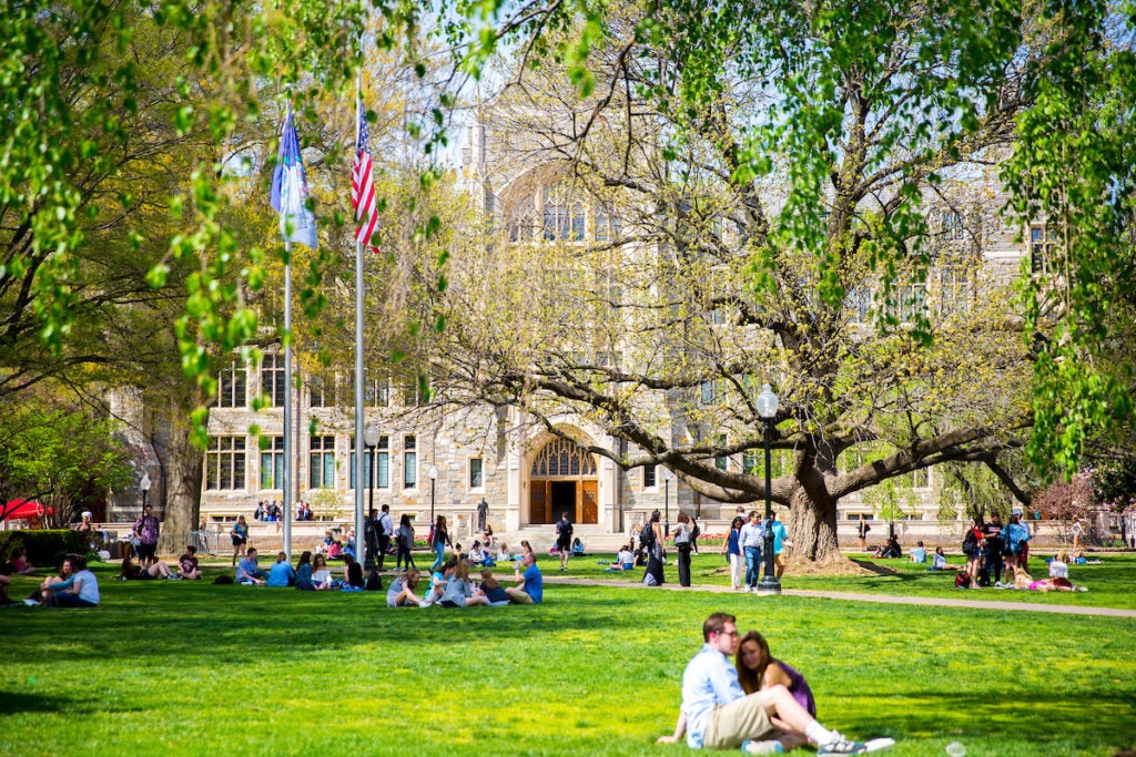 Students sitting on lawn outside of Healy Hall 