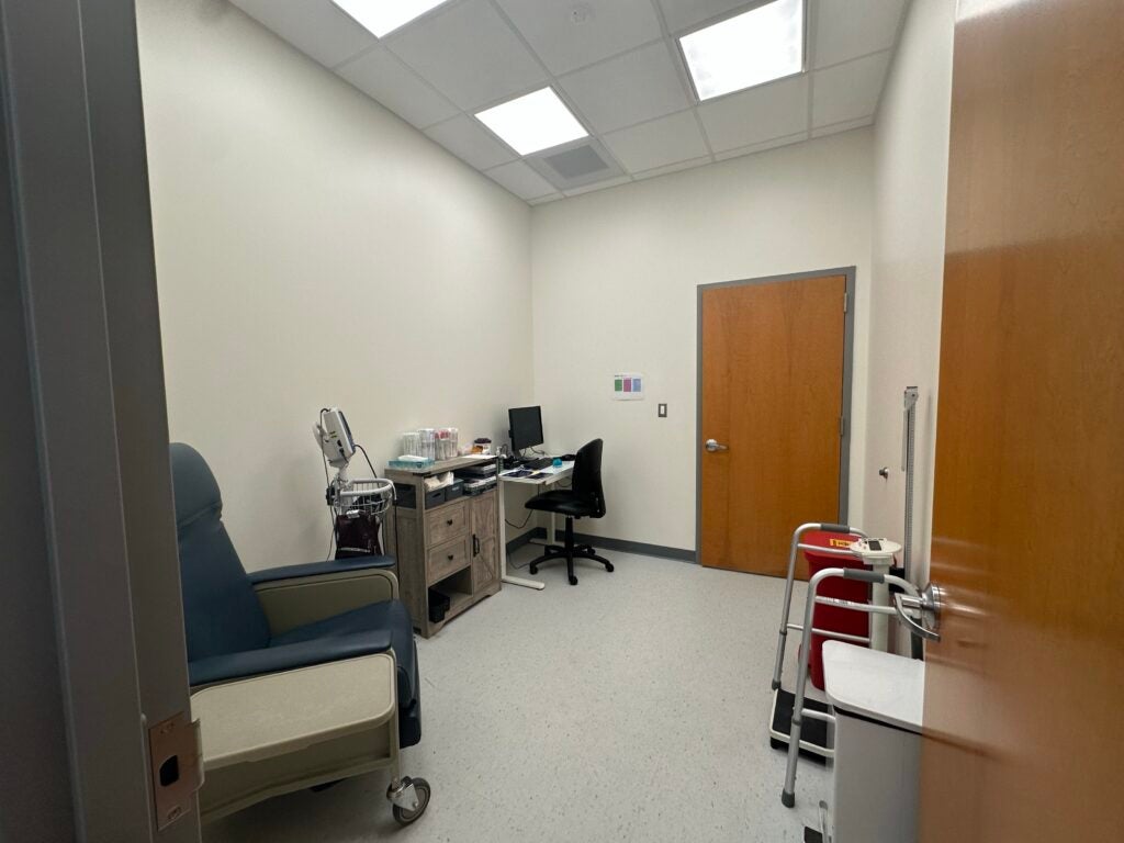 New nursing room in the Student Health Center. Features a lab chair, medical equipment, and a computer.